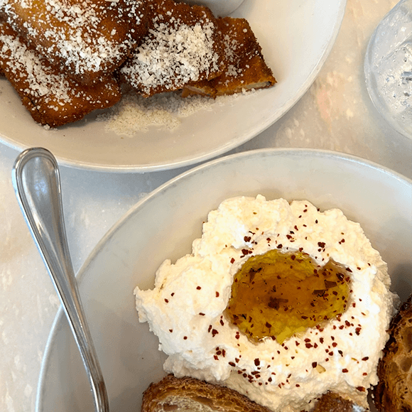 Meet You On The Mat Two white plates: one with pasta squares topped with grated cheese, the other with whipped ricotta, a drizzle of olive oil, chili flakes, and a piece of toasted bread. Pilates & Dance. New York City Food Favs